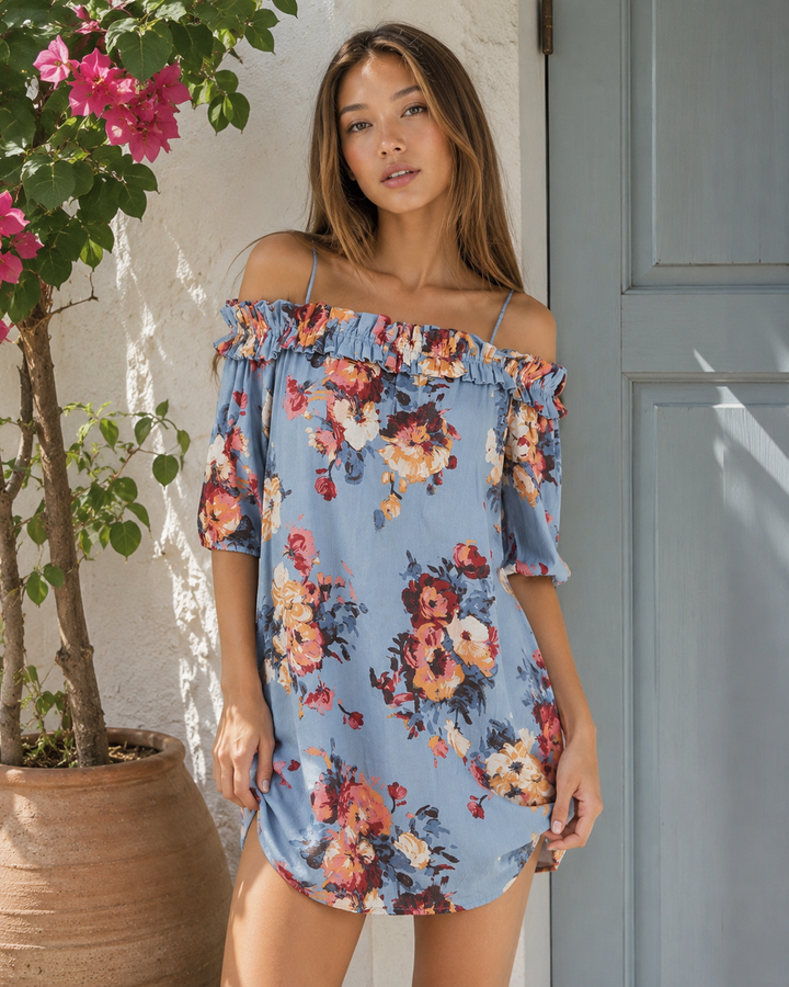 Women's blue floral off-the-shoulder mini dress with a ruffle neckline, adjustable spaghetti straps, relaxed fit, and colorful watercolor floral print.