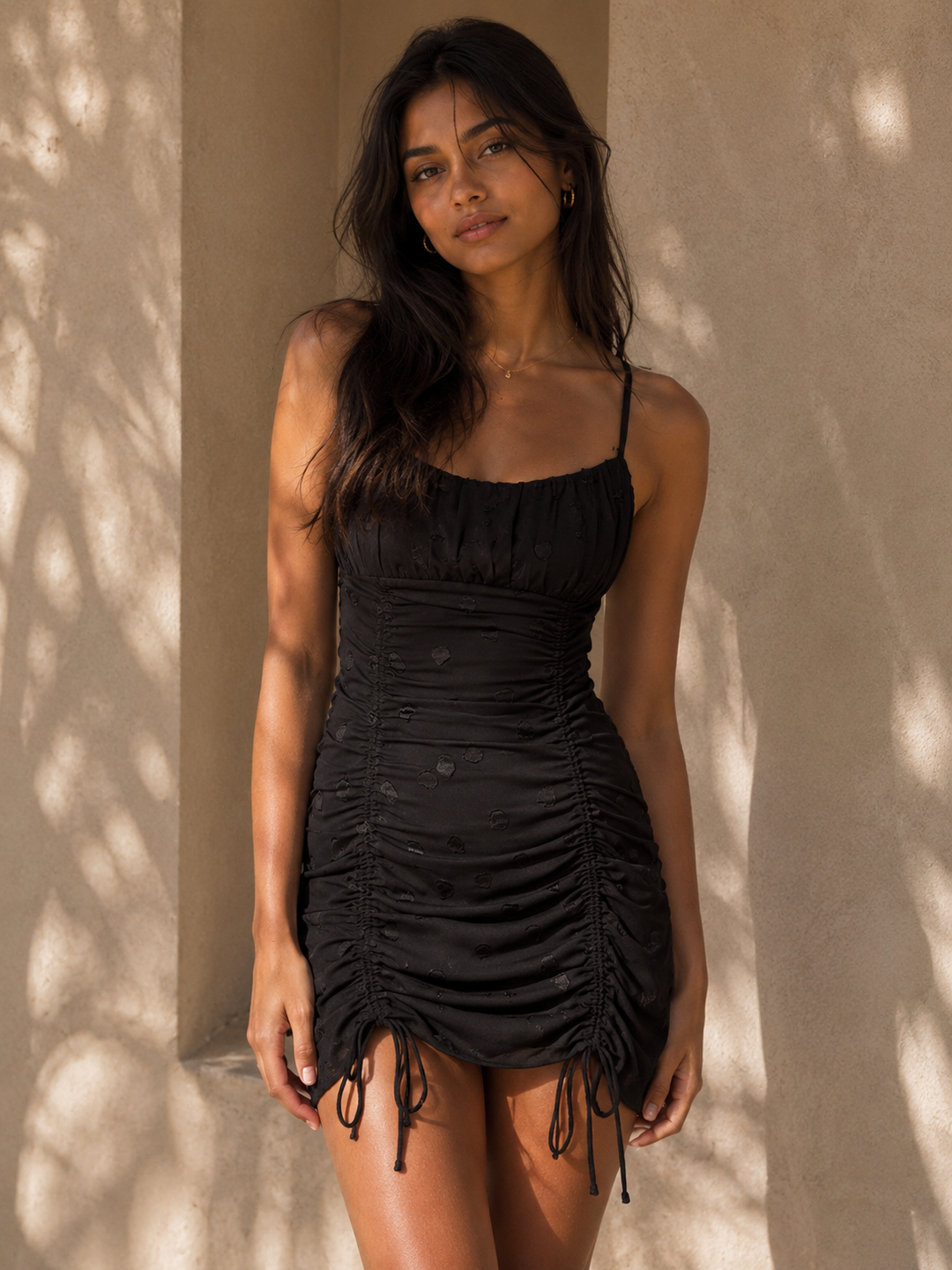 Cotton Candy LA black textured polka dot bodycon mini dress with scoop neckline and adjustable ruched drawstring detailing.