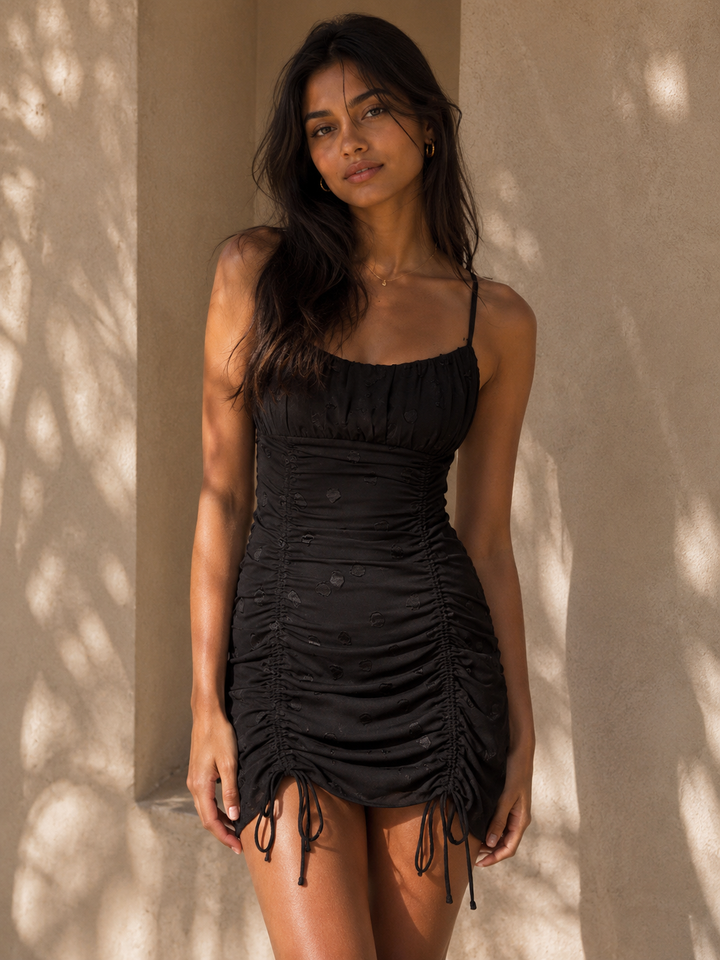 Cotton Candy LA black textured polka dot bodycon mini dress with scoop neckline and adjustable ruched drawstring detailing.