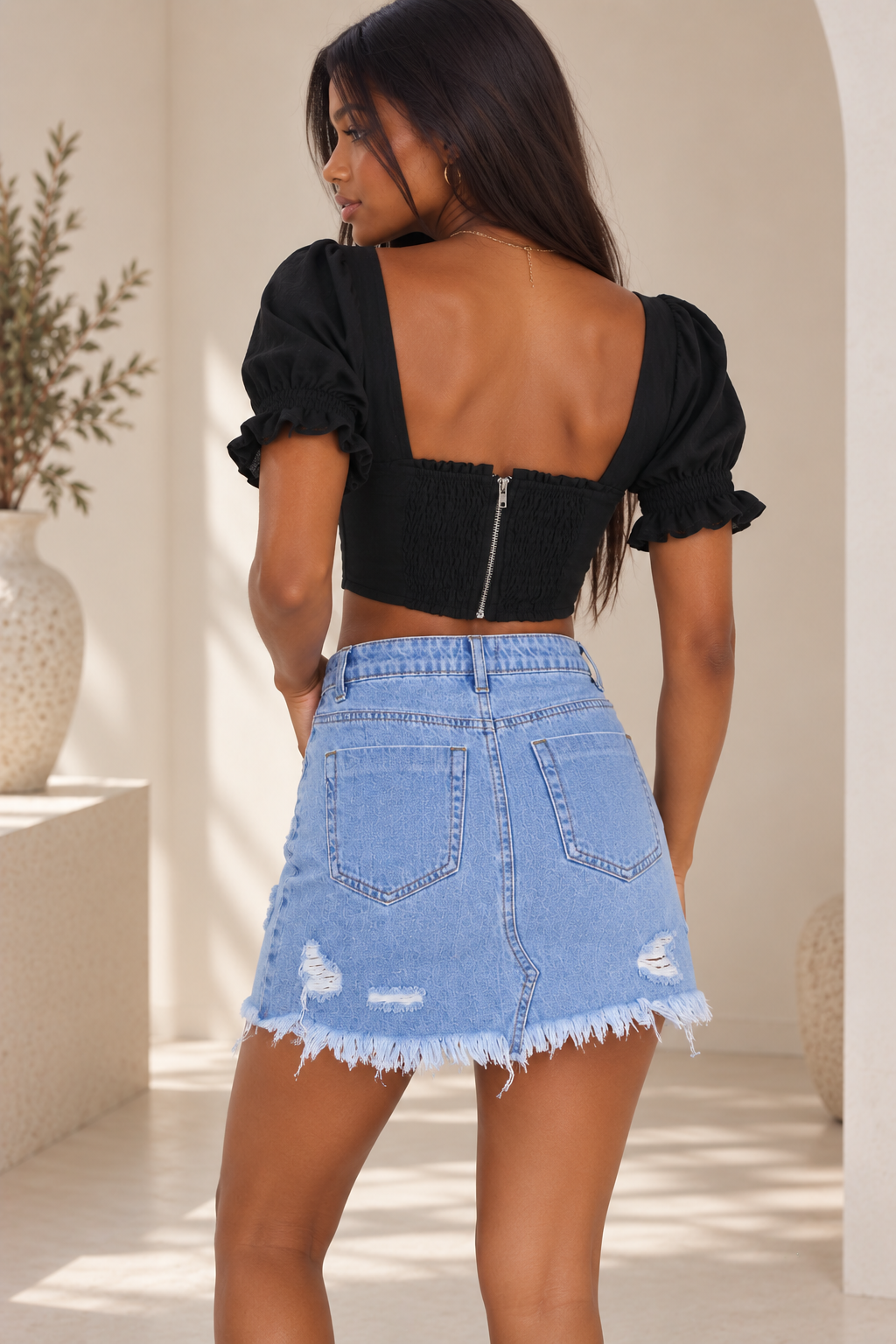 Daya light wash distressed denim mini skirt back view with patch pockets and frayed raw hem