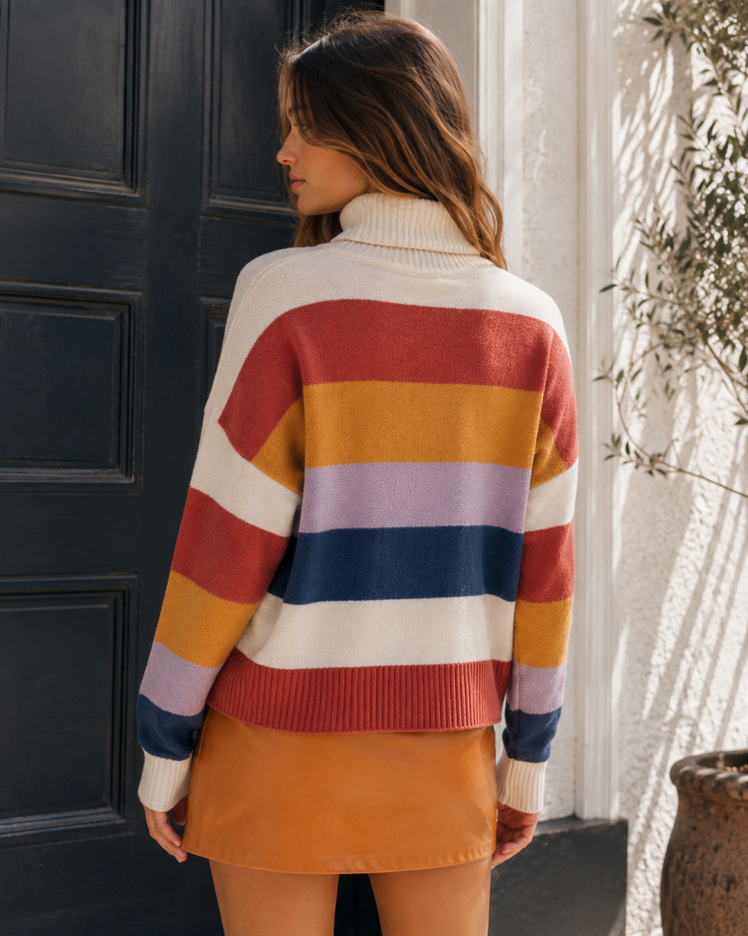Back view of the MINKPINK Be Bold Stripe Knit Sweater with multicolor horizontal stripe design.