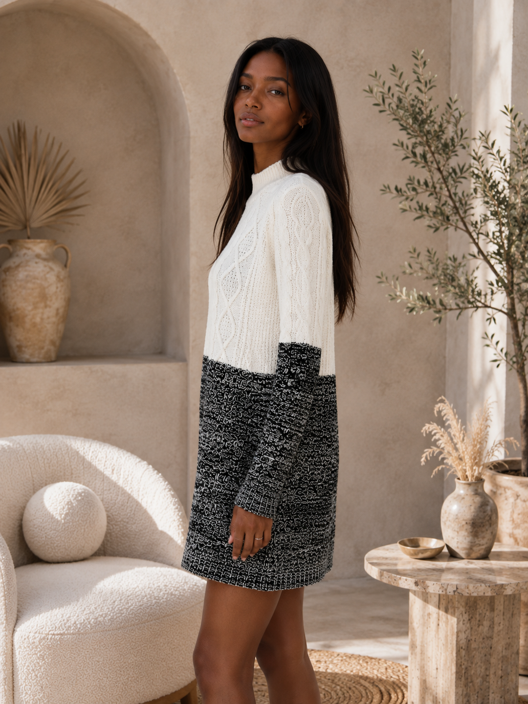Side view of Minkpink Two Faced black and ivory cable knit mini sweater dress with relaxed silhouette.