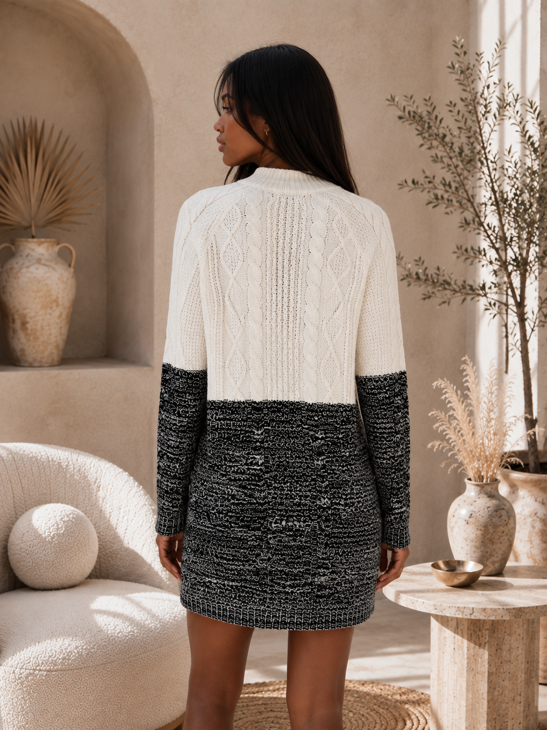 Back view of Minkpink Two Faced cable knit sweater dress featuring ivory cable knit and contrasting black textured knit.

