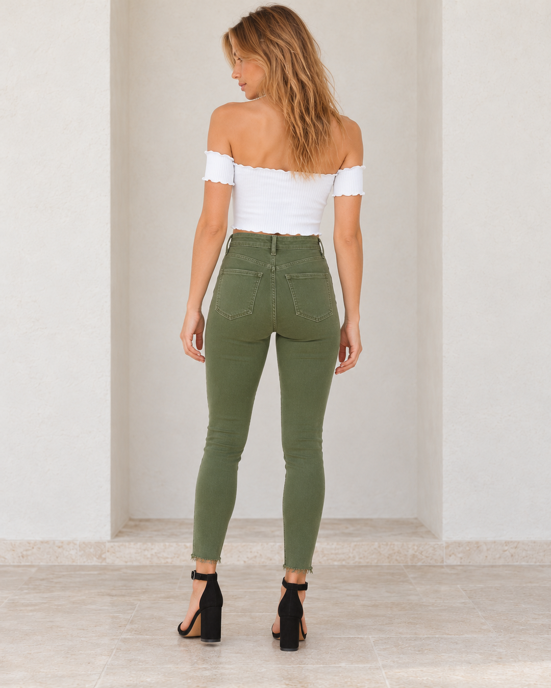Army green Raw Hem Skinny Jeans, rear outfit view showing the back yoke, patch pockets and raw hems.