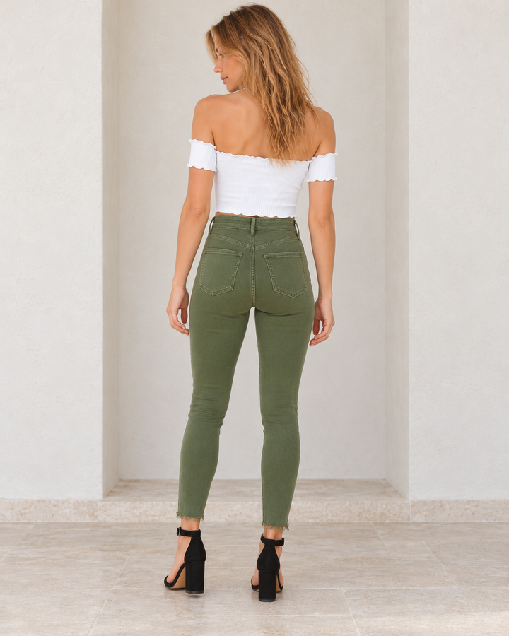 Army green Raw Hem Skinny Jeans, rear outfit view showing the back yoke, patch pockets and raw hems.