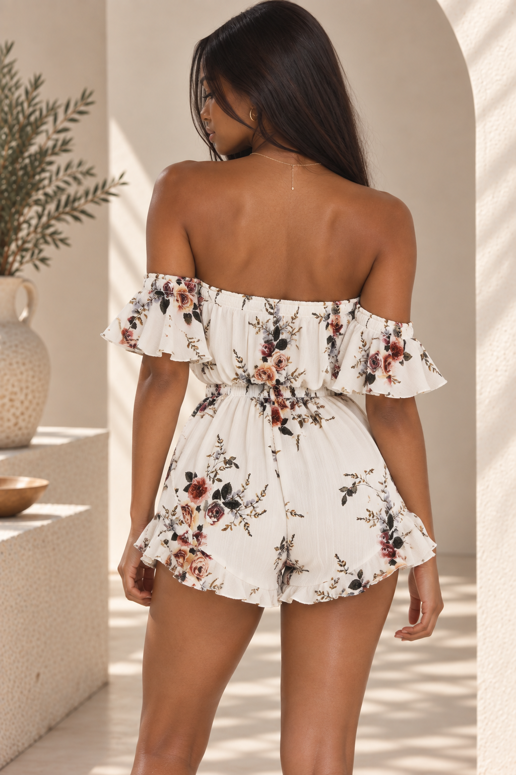 Running Late ivory floral off-the-shoulder romper with elastic waist and ruffle shorts back view