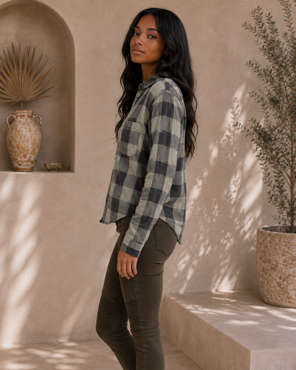 Side view of Sea Gypsies Coney charcoal plaid button-front shirt with relaxed fit and curved hem.