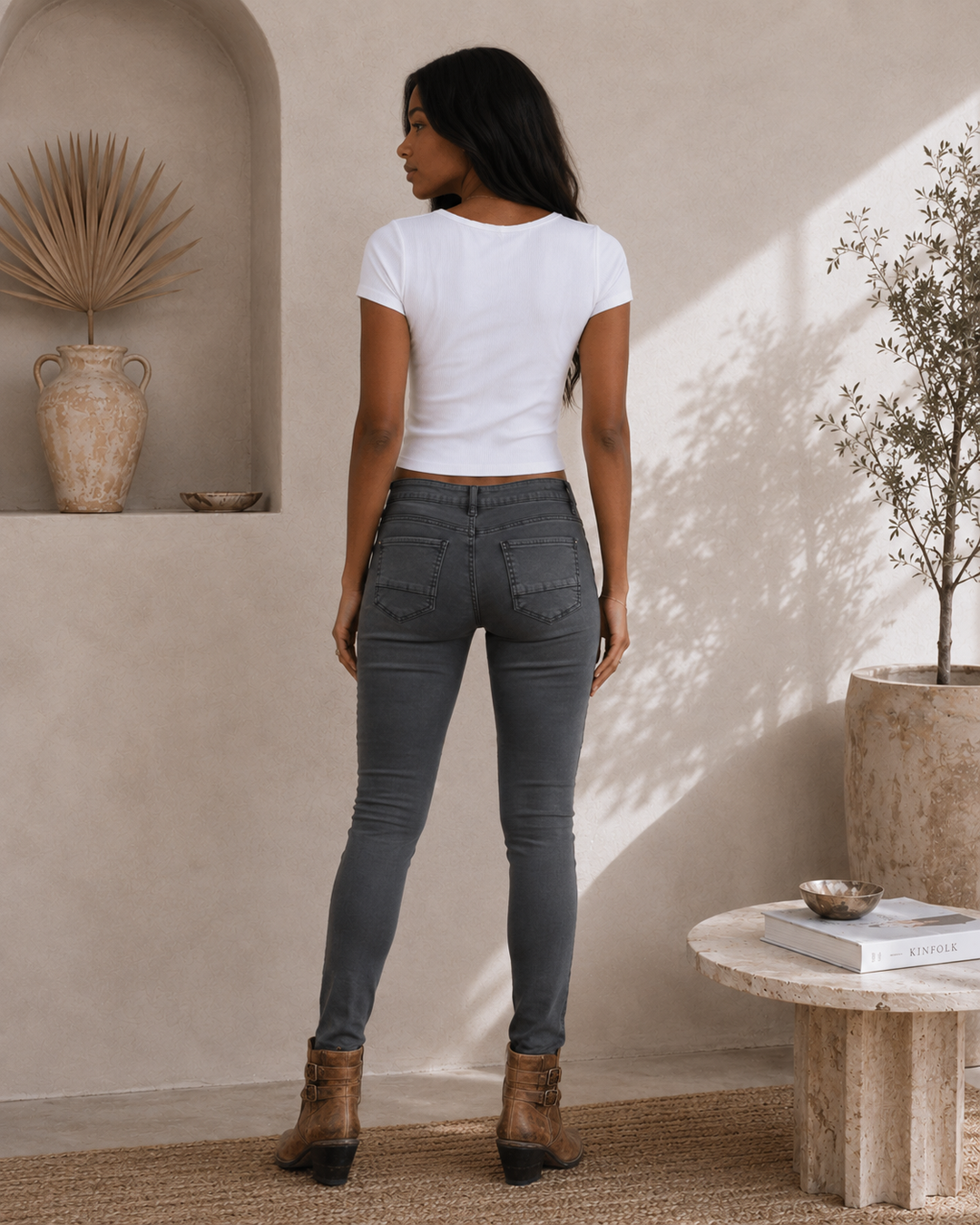 Back view of women's charcoal skinny biker jeans with fitted silhouette and back patch pockets.