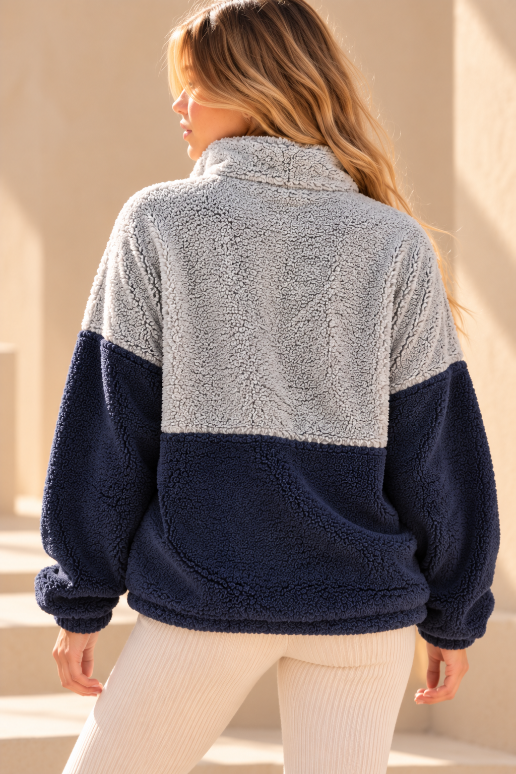 Back view of blue and navy colorblock sherpa pullover