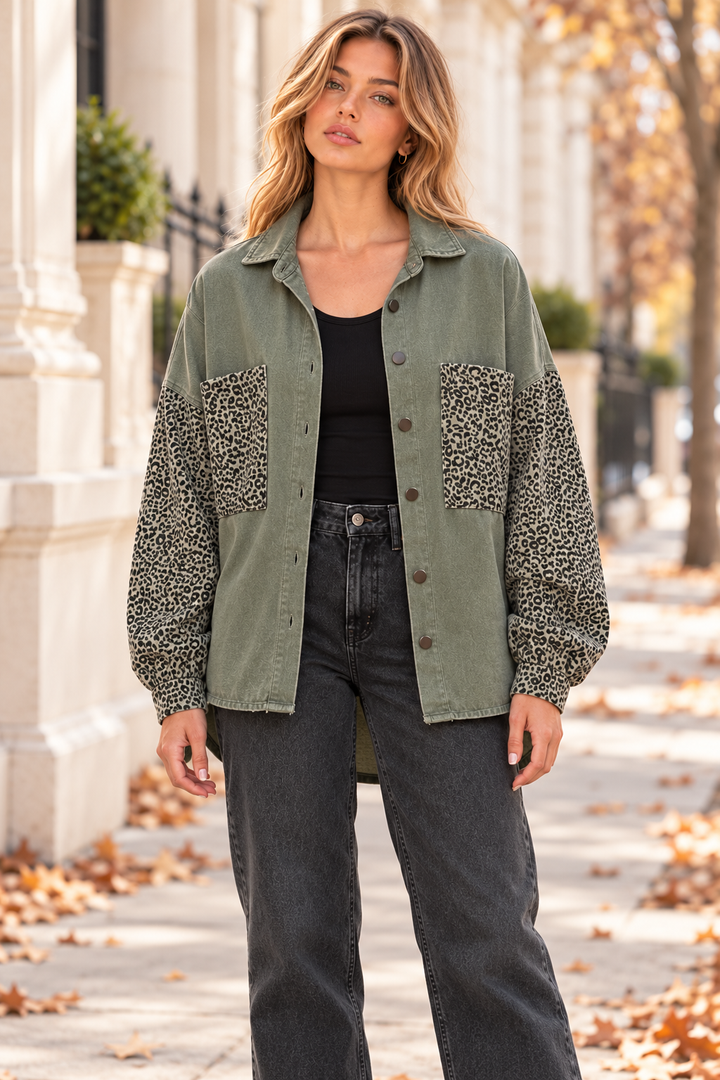 Front view of olive denim shacket with leopard-print sleeves and chest pockets, worn open over a black top.
