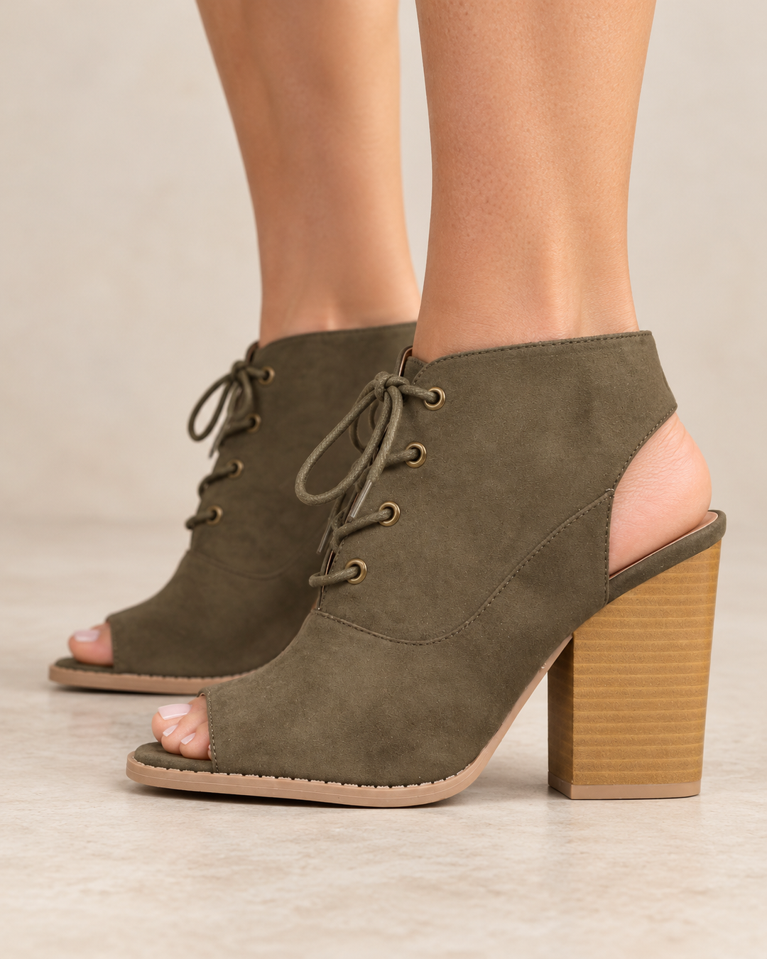 Khaki Adventure lace-up peep-toe booties worn on feet, side view