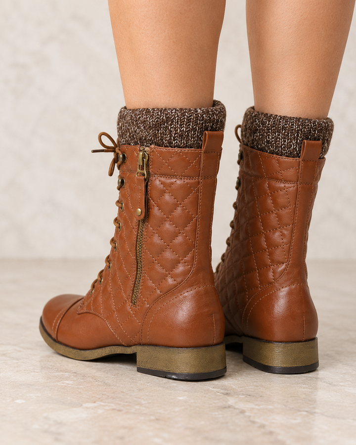 Alpine cognac quilted combat sweater boots worn on feet, back view 