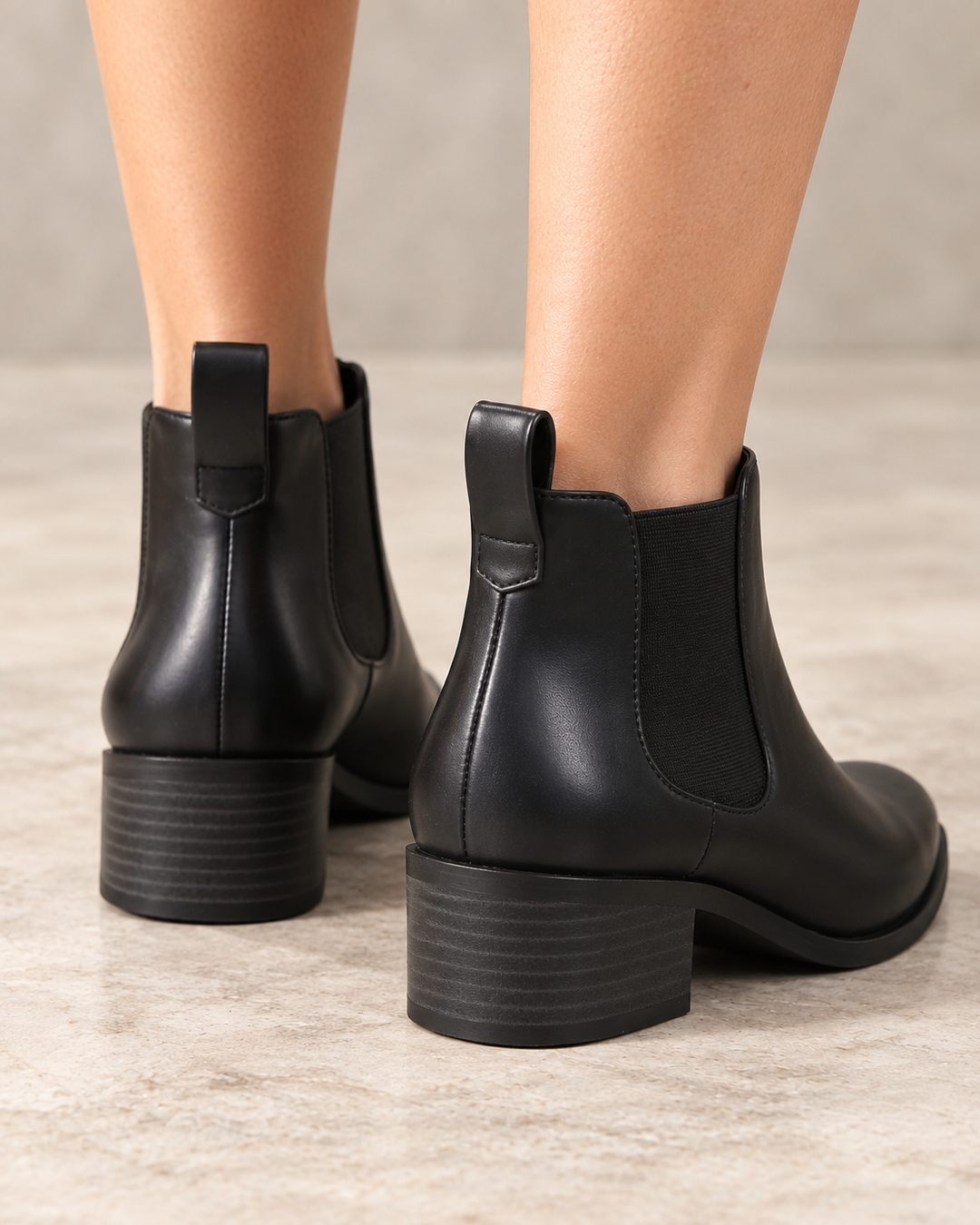 Black BC Footwear Partner Chelsea ankle boots worn on feet, rear three-quarter view