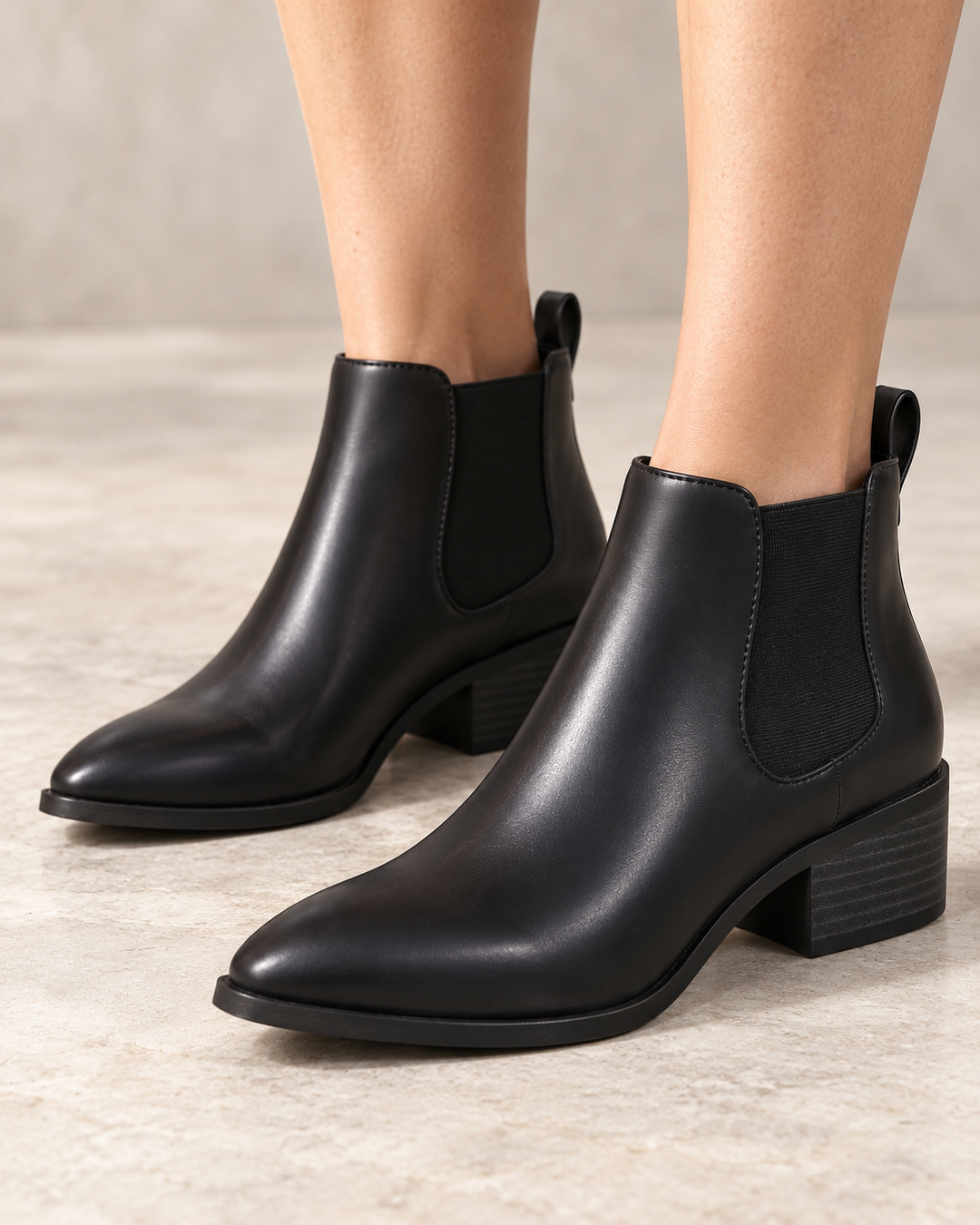 Black BC Footwear Partner Chelsea ankle boots worn on feet, front three-quarter view