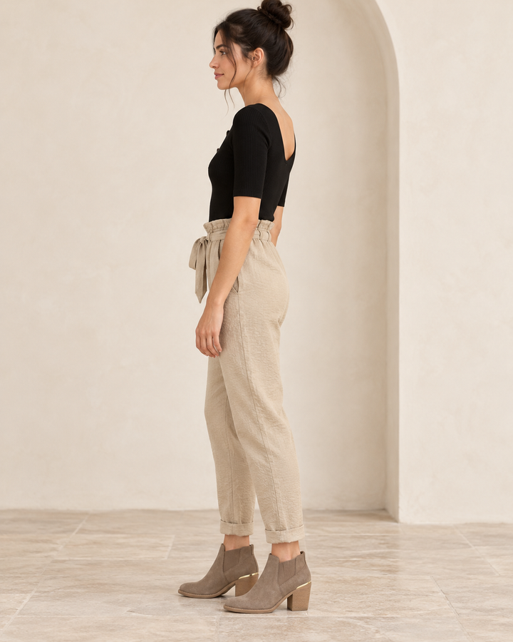 Wishlist Beatrice black ribbed button-front bodysuit, side view on a model styled with beige linen pants and taupe ankle boots. 