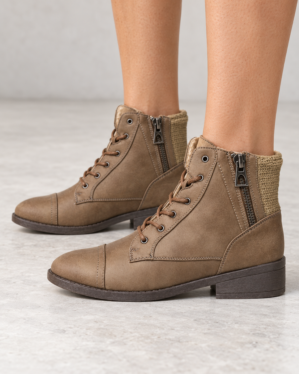 Brielle taupe ankle sweater booties, modeled side view showing side zippers and knit back panels