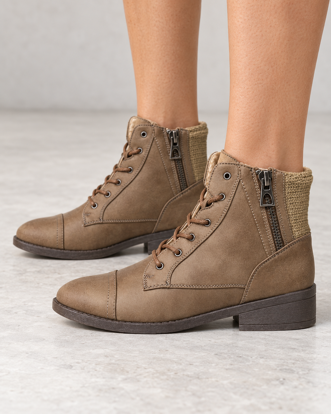 Brielle taupe ankle sweater booties, modeled side view showing side zippers and knit back panels