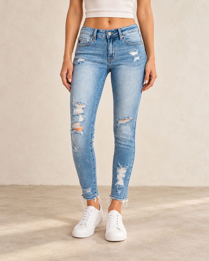 Front view of Lizzy distressed light-wash skinny jeans on a model, showing the faded wash and distressed legs.