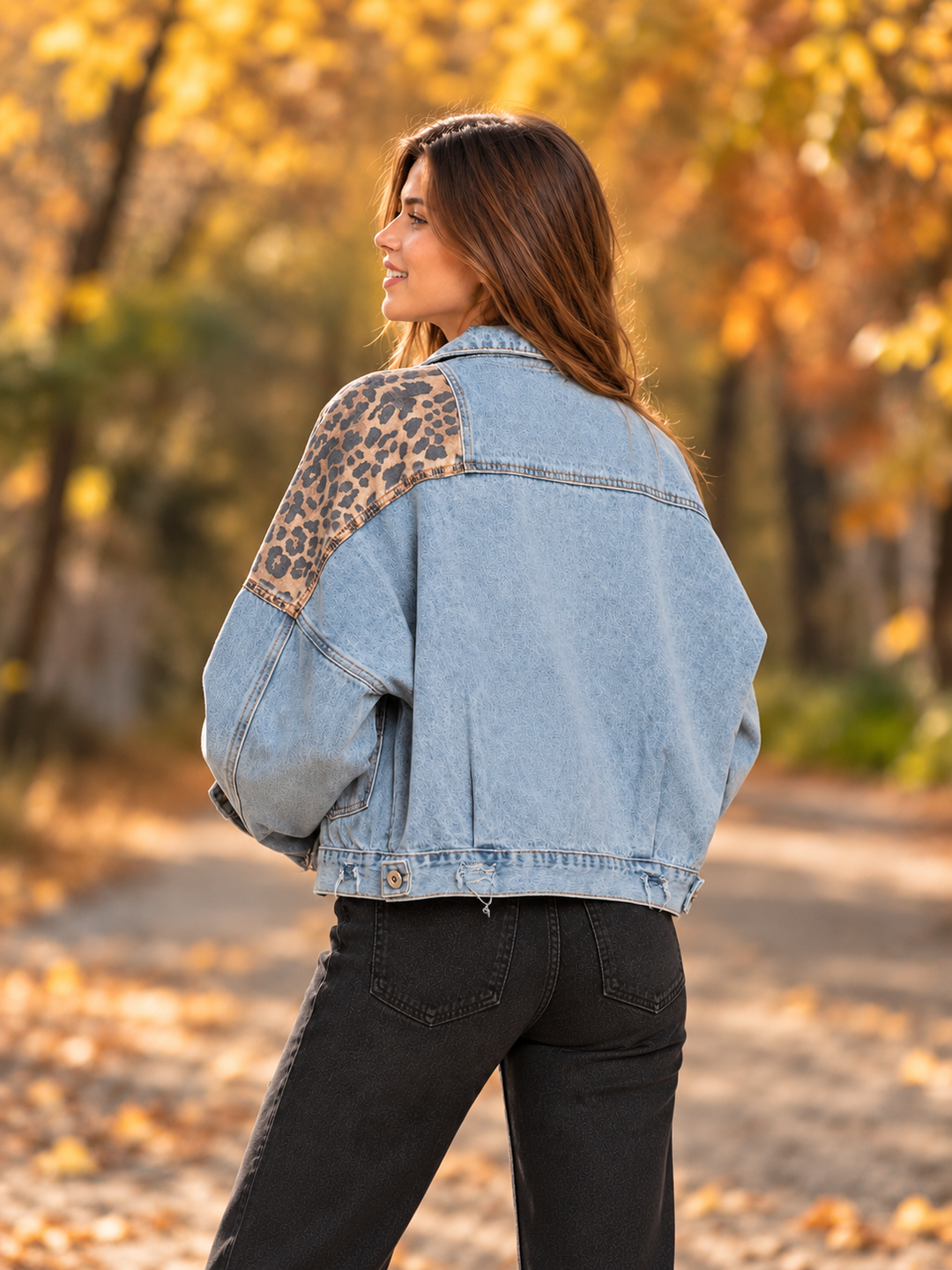 Rear three-quarter view of the Off Duty leopard denim jacket in light blue denim, showing the leopard shoulder panel and denim back.