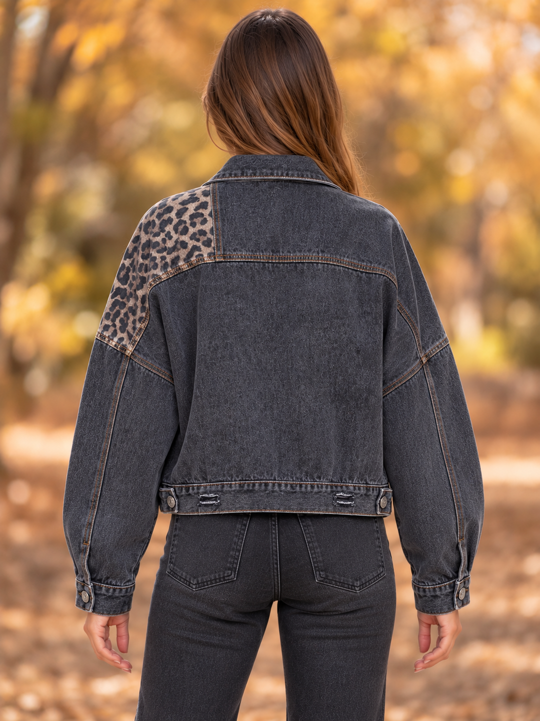 Back view of the Off Duty leopard denim jacket in vintage black, showing its asymmetric contrast panels.