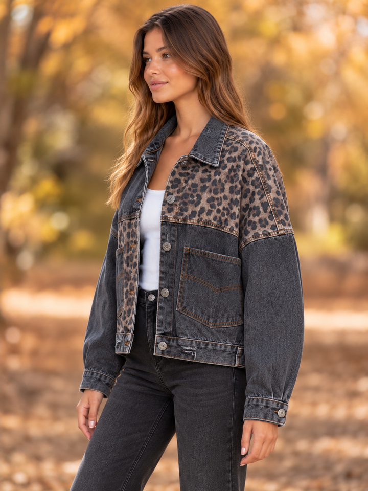 Side view of the Off Duty leopard denim jacket in vintage black, showing its asymmetric contrast panels.