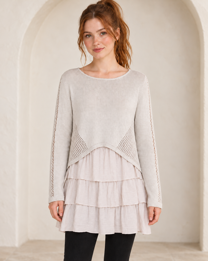 Khaki open-knit ruffle-hem sweater tunic, front view on a model showing the scoop neckline, openwork side panels and three layered ruffles.