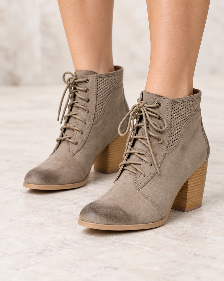 Point the Way taupe perforated ankle boots worn on feet, front view 
