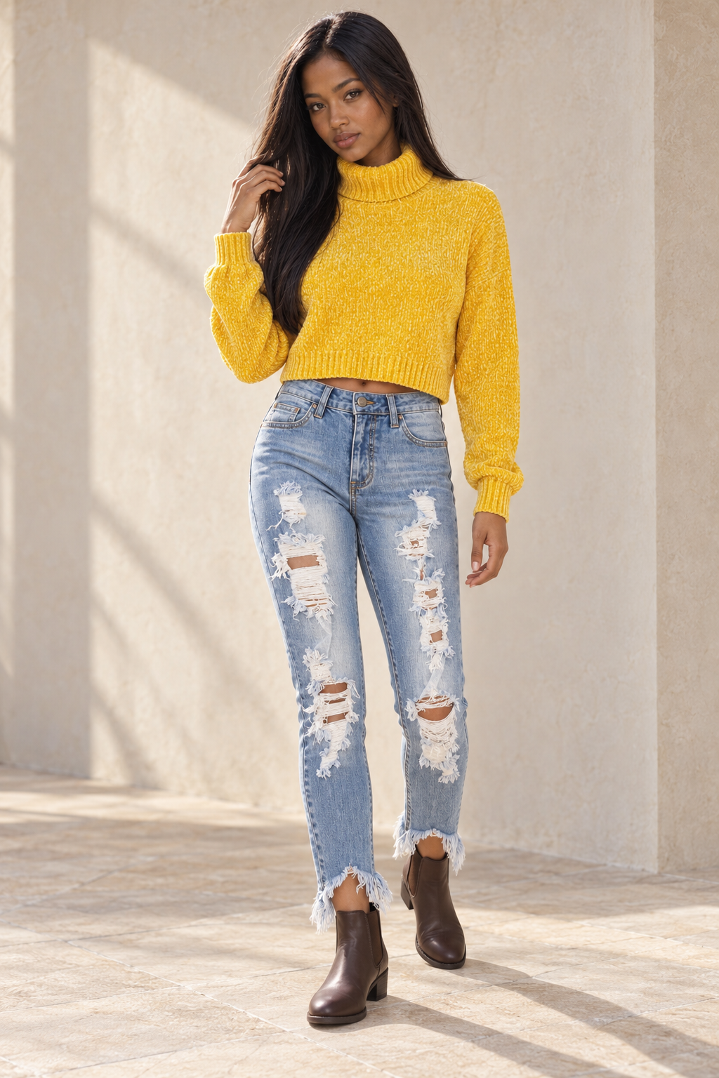 Cotton Candy mustard cropped rib-knit turtleneck on a model with distressed light-wash jeans and brown Chelsea ankle boots.