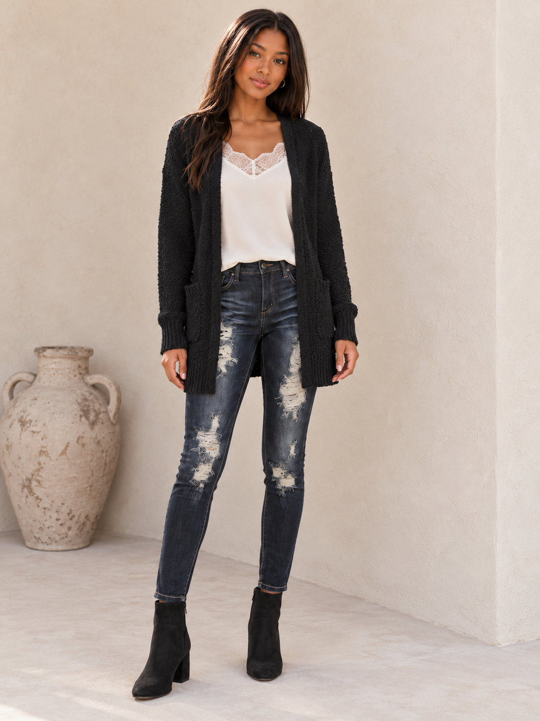 Front view of the black fuzzy pocketed open-front cardigan showing the relaxed open front and patch pockets.