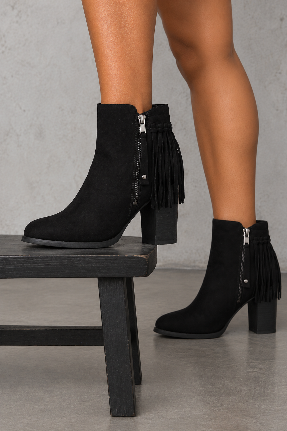 City Chic black fringe vegan-suede ankle boots, side view worn on feet in a neutral studio.