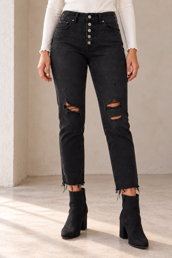 Free People Blossom Rigid Skinny Jeans in Day or Night Black, closer view on an adult model in warm natural daylight, showing the original denim construction with top and footwear.