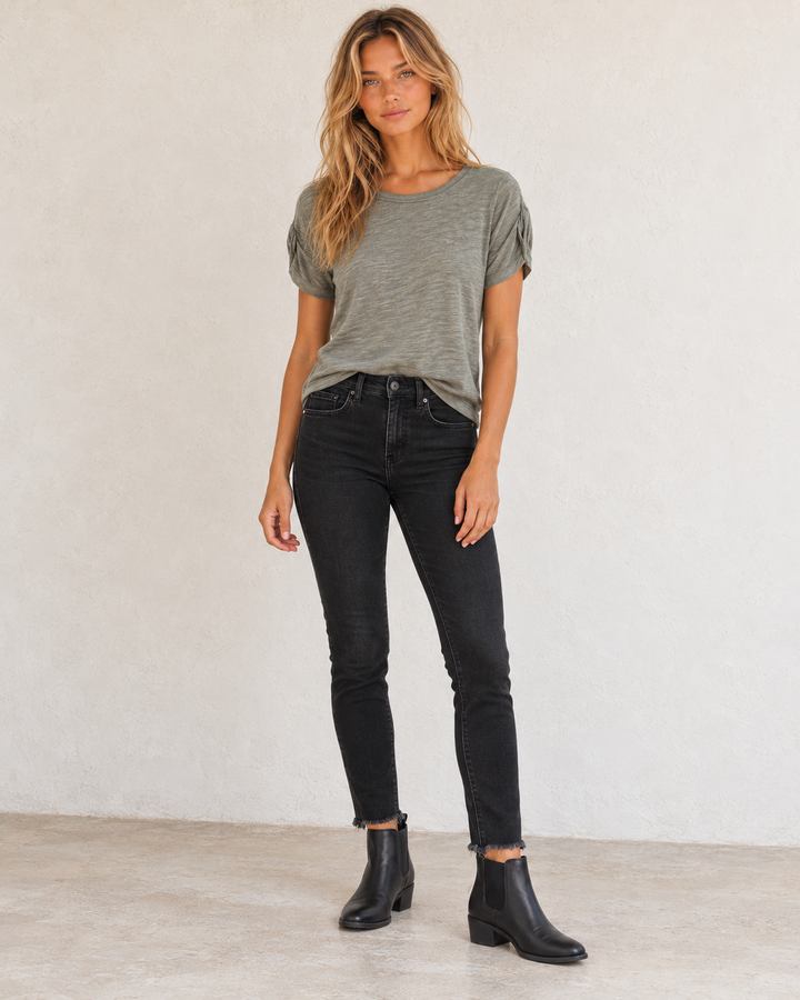 Free People Raw high-rise black jeggings styled with the Clare green tee and black Chelsea ankle boots.