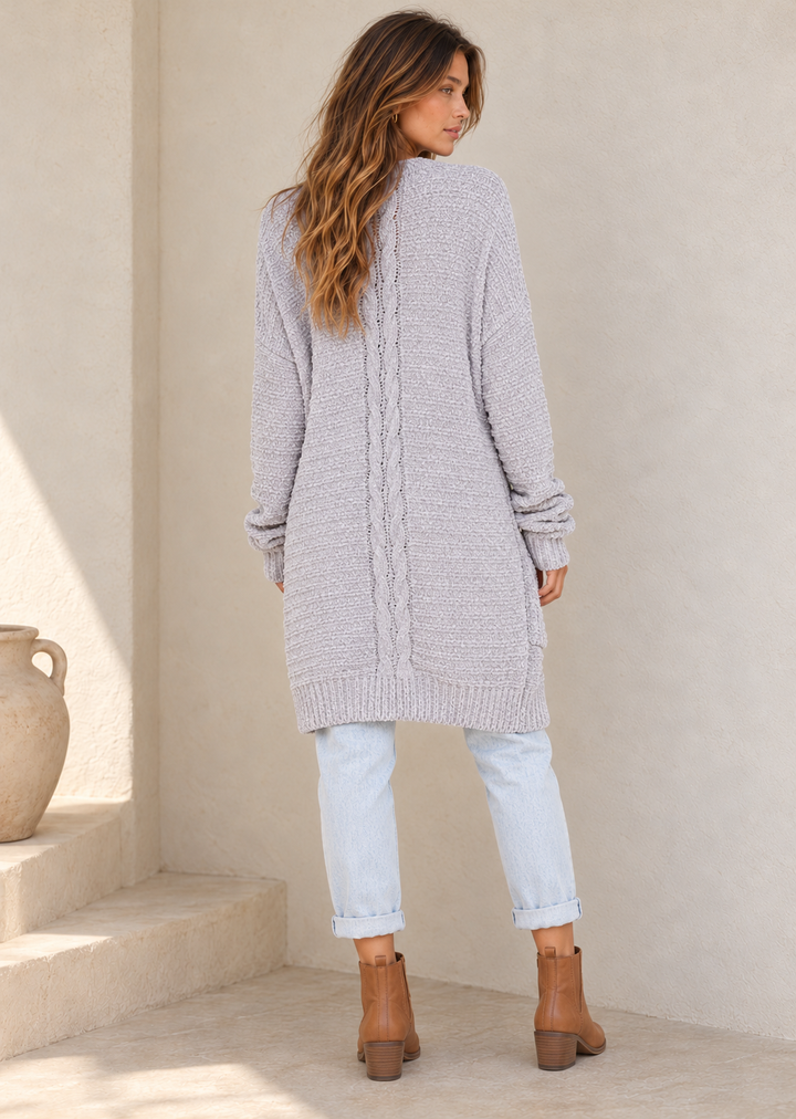 Silver chenille open-front shawl cardigan with patch pockets and ribbed trim, back view on a model in warm natural daylight.