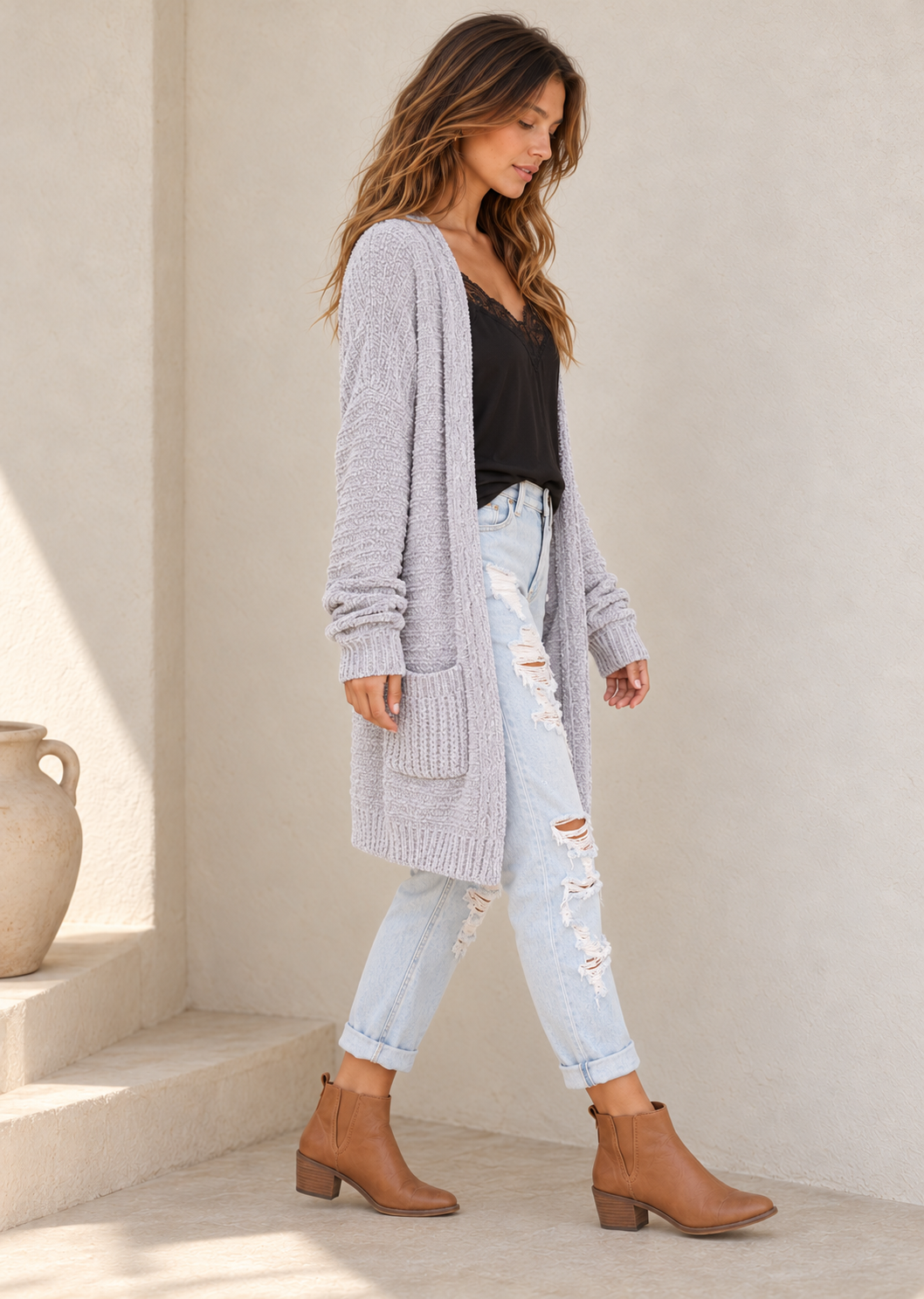 Silver chenille open-front shawl cardigan with patch pockets and ribbed trim, side view on a model in warm natural daylight.