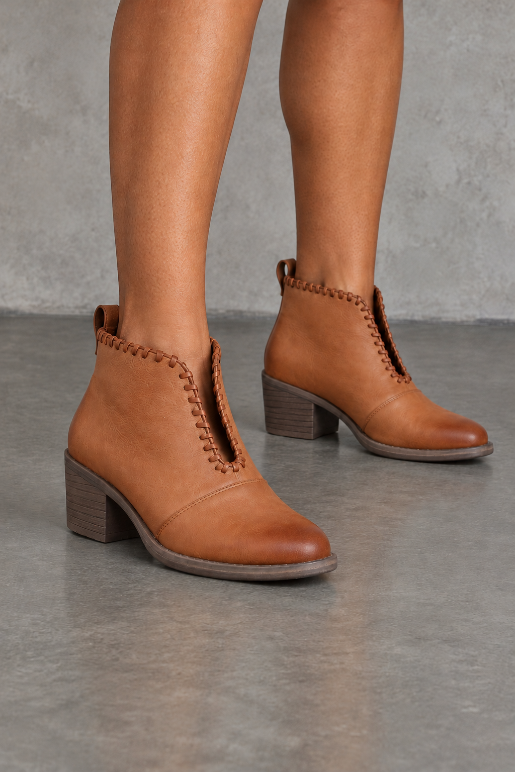 Very Volatile Cavalry tan ankle booties with V-cut openings, front view worn on feet in a neutral studio.