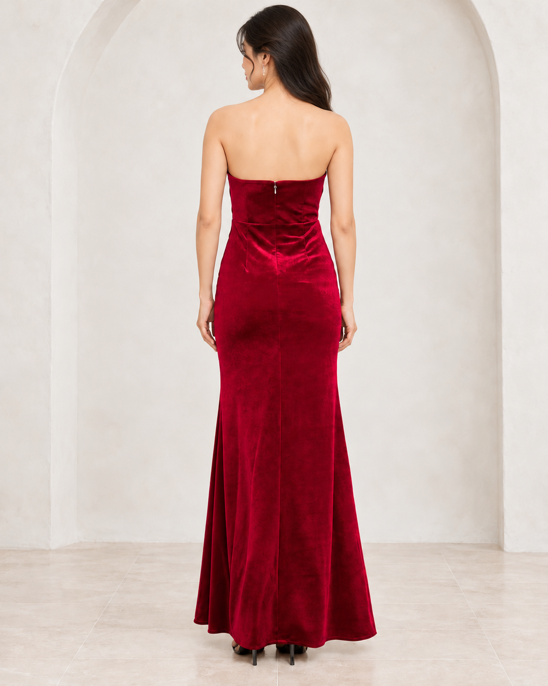 Burgundy twist-front strapless velvet maxi dress, back view showing straight back neckline and center zipper.