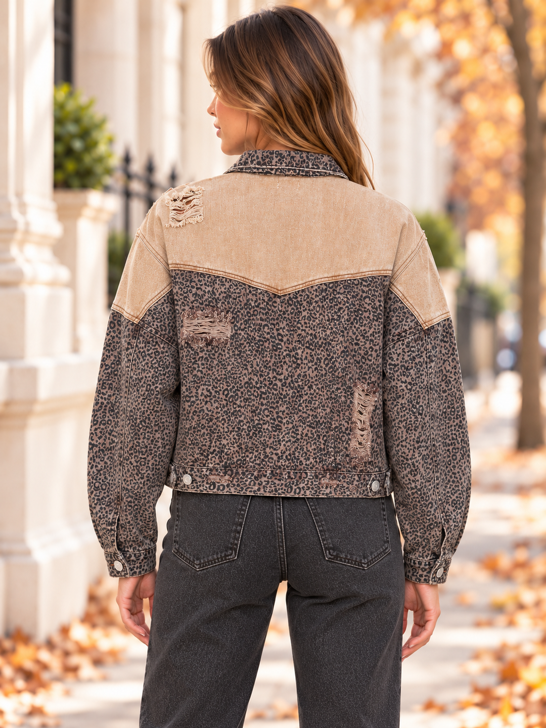 Back view of the caramel distressed leopard denim jacket with a contrasting tan yoke.