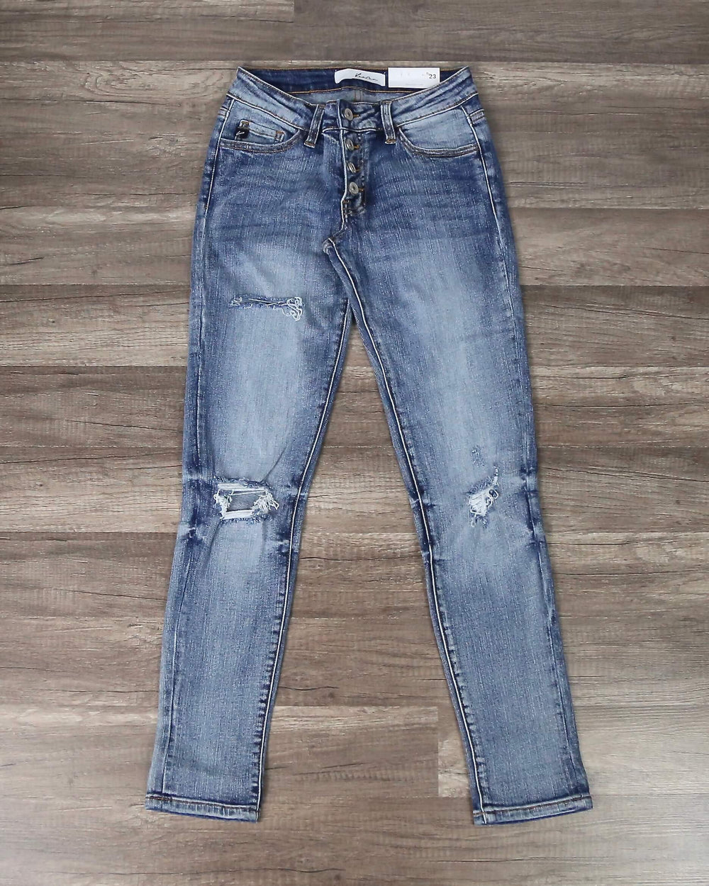 Mia distressed medium-wash skinny jeans, front flat lay showing faded wash and ripped knees