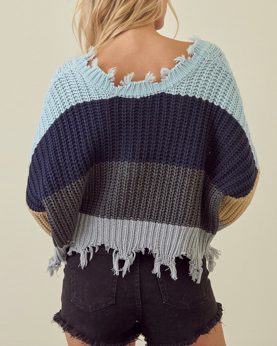 STORIA Distressed V-Neck Cropped Knit Sweater in Blue/Grey, back model view showing horizontal stripes and cropped hem