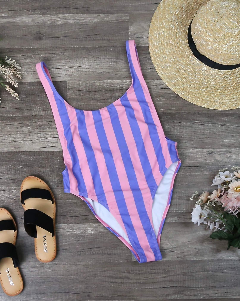 Motel Goddess One Piece Swimsuit in Fairground Stripe front flat lay with scoop neckline and pink and blue striped print