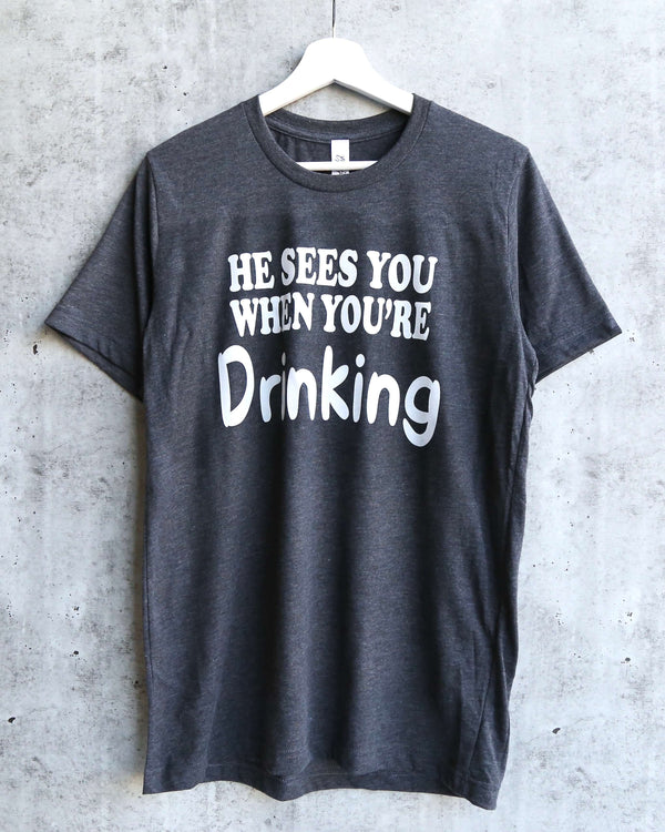Distracted - He Sees You When You're Drinking Christmas Unisex Graphic Tee in Dark Heather Grey