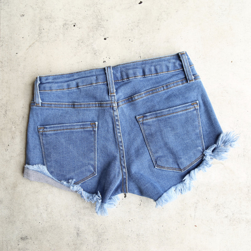 Low Rise Fitted Cut Off Distressed Shorts in Mid Wash Denim